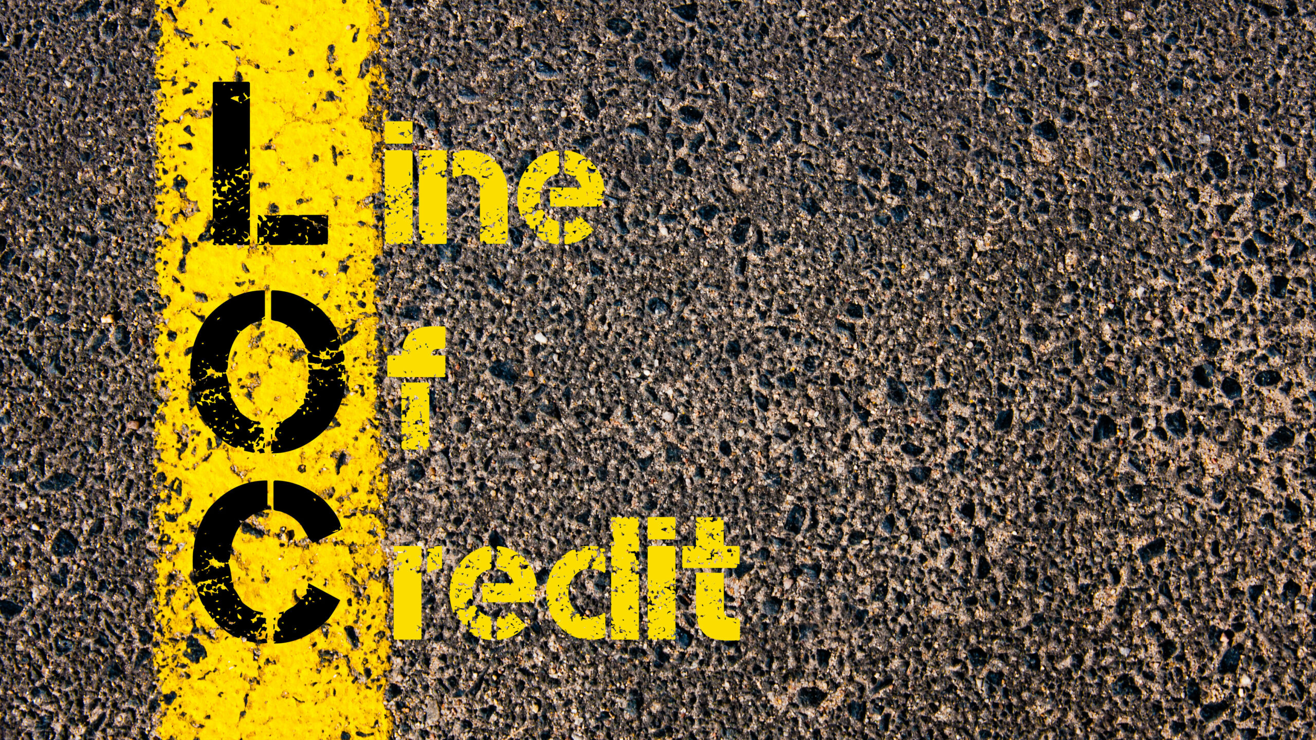 Concept image of Business Acronym LOC as Line Of Credit written over road marking yellow paint line.